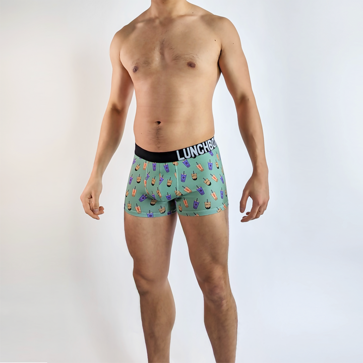 Model wearing Boba Bubble Tea Boxer Briefs with playful bubble tea patterns (front).