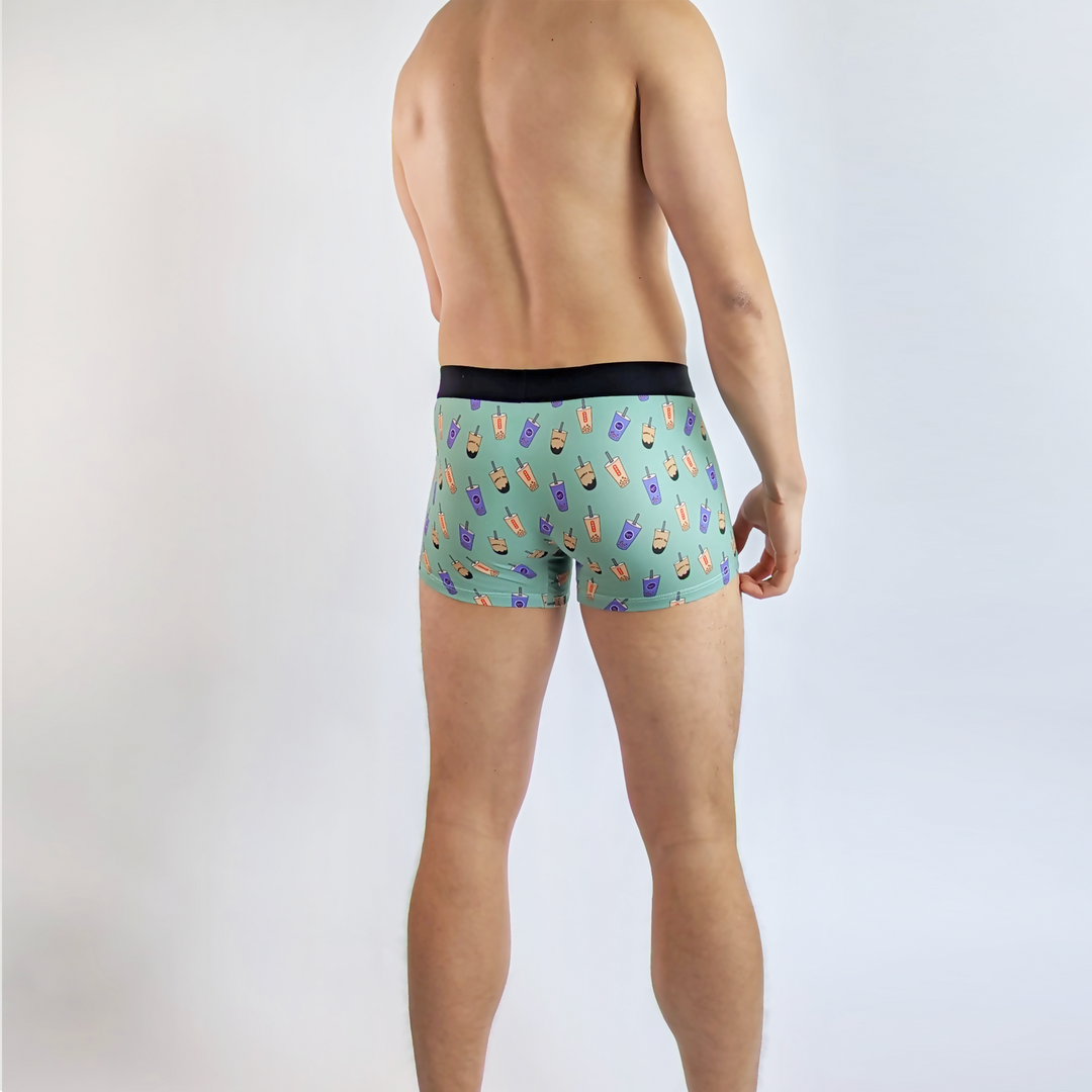 Model wearing Boba Bubble Tea Boxer Briefs with playful bubble tea patterns (rear).