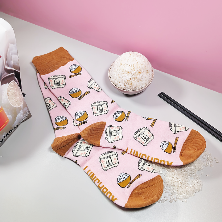 "RiceRiceRice" Rice Lover Socks featuring a rice bowl and rice cooker in the design, with a bowl of rice and chopstick beside it.