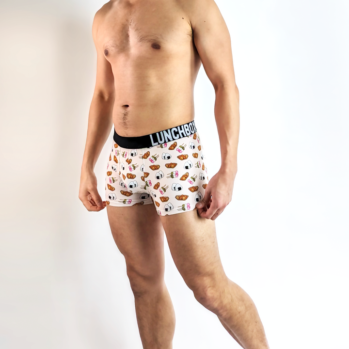 Model wearing Japanese Delights boxer briefs featuring dango and onigiri designs.